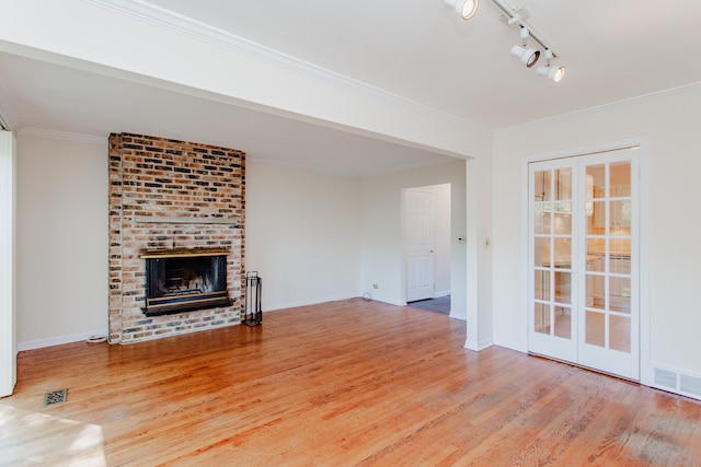 590 Green Bay Rd, Glencoe, IL 60022 - unfurnished living room with wood finished floors, a fireplace, crown molding, and track lighting