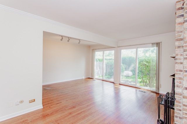 590 Green Bay Rd, Glencoe, IL 60022 - unfurnished living room featuring rail lighting, wood finished floors, and crown molding