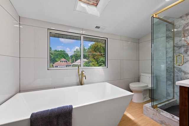 605 Home Ave, Oak Park, IL 60304 - full bathroom featuring a soaking tub, tile walls, a stall shower, vanity, and wood finished floors