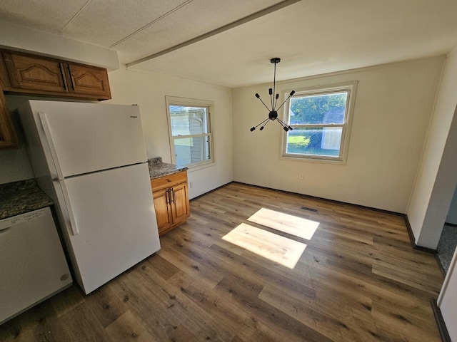 508 W Clark St, Thomasboro, IL 61878 - kitchen with white appliances, a chandelier, wood finished floors, brown cabinets, and pendant lighting