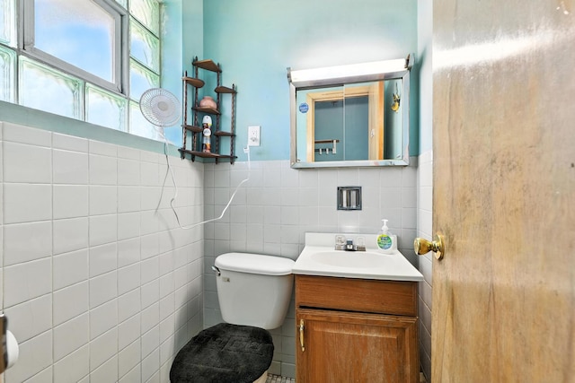 16632 Emerald Ave, Harvey, IL 60426 - bathroom featuring tile walls, vanity, and a wainscoted wall