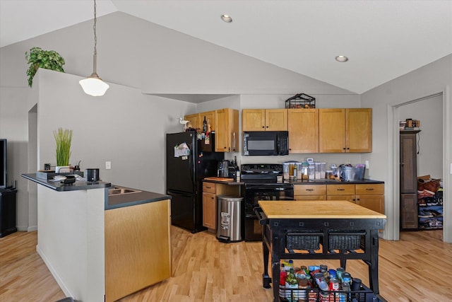 21 County Road 1200 N, Neoga, IL 62447 - kitchen with black appliances, dark countertops, light wood-style floors, hanging light fixtures, and high vaulted ceiling
