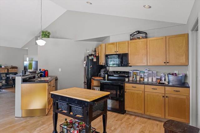 21 County Road 1200 N, Neoga, IL 62447 - kitchen with black appliances, dark countertops, a peninsula, light wood finished floors, and hanging light fixtures