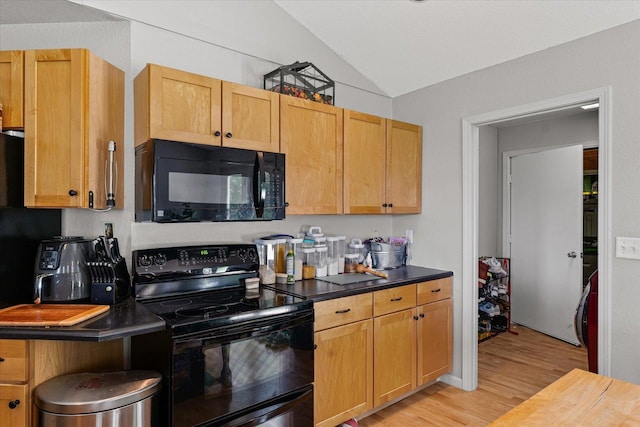 21 County Road 1200 N, Neoga, IL 62447 - kitchen with black appliances, light wood finished floors, lofted ceiling, and dark countertops