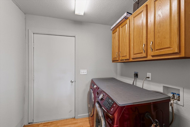 21 County Road 1200 N, Neoga, IL 62447 - laundry room with independent washer and dryer, cabinet space, light wood-style floors, and a textured ceiling