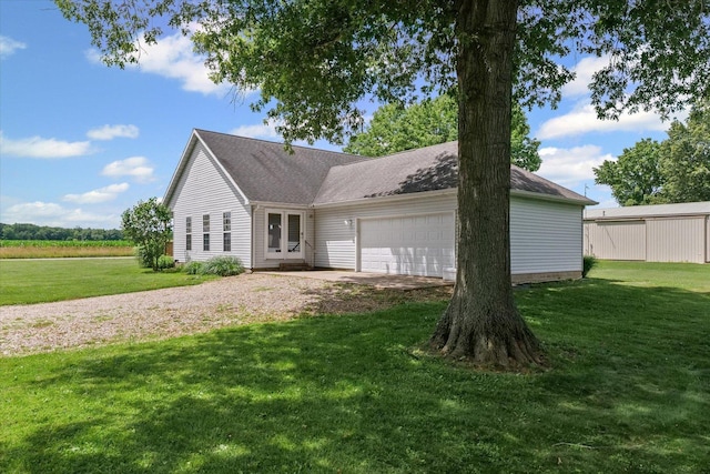 21 County Road 1200 N, Neoga, IL 62447 - view of front of house featuring driveway, an attached garage, and a front yard