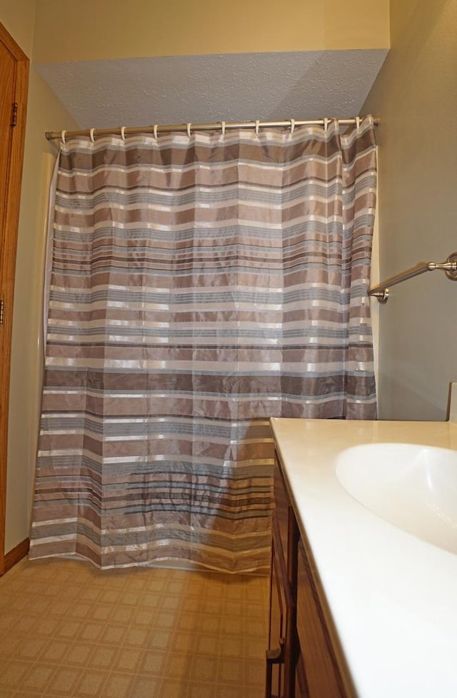 6924 Cody Ln, Rockford, IL 61107 - bathroom with vanity, a textured ceiling, a shower with curtain, and tile patterned floors
