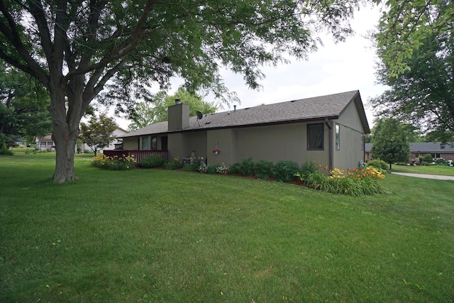 6924 Cody Ln, Rockford, IL 61107 - rear view of property with a chimney, a lawn, and a wooden deck