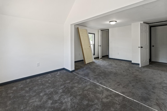 1213 W Fourth St, Dixon, IL 61021 - empty room featuring dark carpet and vaulted ceiling