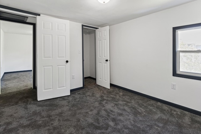 1213 W Fourth St, Dixon, IL 61021 - unfurnished bedroom featuring dark carpet and baseboards