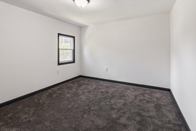 1213 W Fourth St, Dixon, IL 61021 - unfurnished room with dark carpet and baseboards