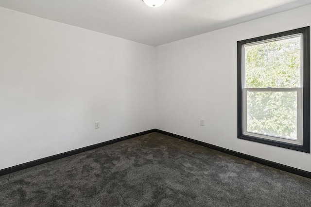 1213 W Fourth St, Dixon, IL 61021 - unfurnished room featuring dark colored carpet and baseboards