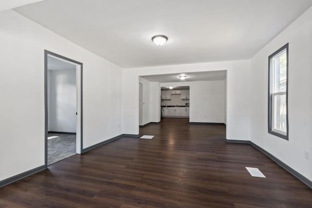 1213 W Fourth St, Dixon, IL 61021 - empty room with dark wood-style floors and baseboards