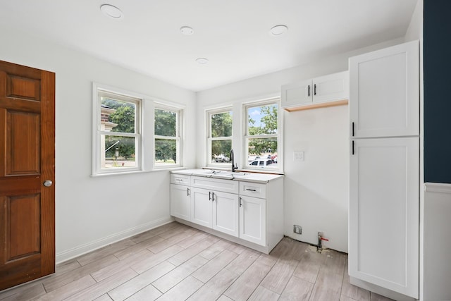 3832 W 81st St, Chicago, IL 60652 - kitchen featuring light countertops, light wood-style flooring, and white cabinets