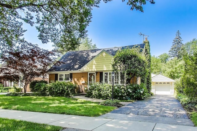 210 N Russel St, Mount Prospect, IL 60056 - view of front of home featuring a front yard, a garage, a chimney, and brick siding
