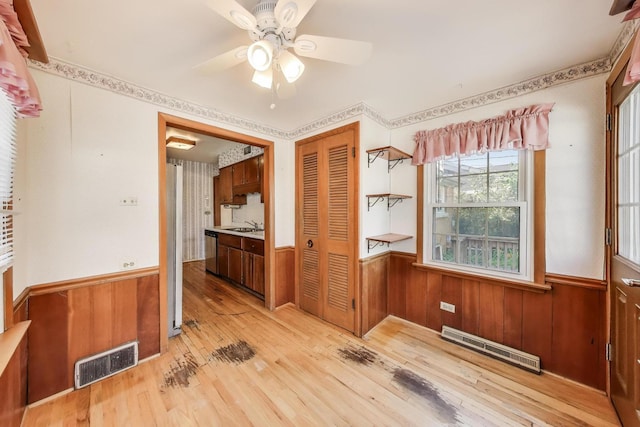 210 N Russel St, Mount Prospect, IL 60056 - unfurnished room with wainscoting, ceiling fan, light wood-style flooring, and wood walls
