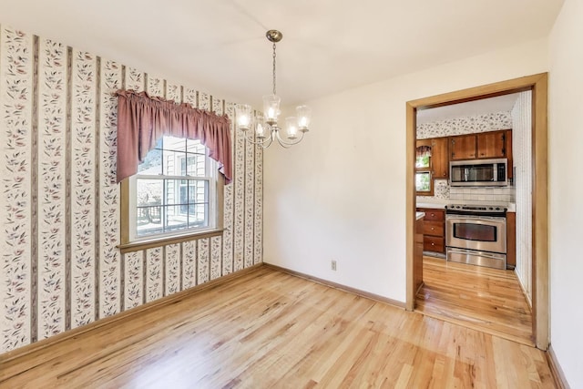 210 N Russel St, Mount Prospect, IL 60056 - unfurnished dining area featuring light wood-type flooring, a chandelier, and wallpapered walls
