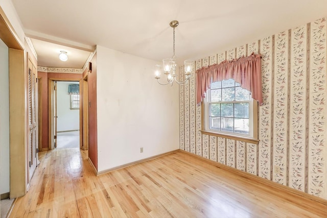 210 N Russel St, Mount Prospect, IL 60056 - spare room with wood finished floors, a chandelier, and wallpapered walls