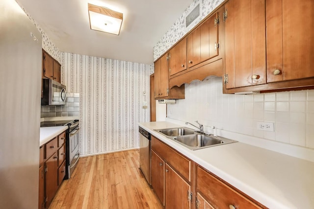 210 N Russel St, Mount Prospect, IL 60056 - kitchen featuring appliances with stainless steel finishes, wallpapered walls, light wood-style flooring, brown cabinets, and light countertops