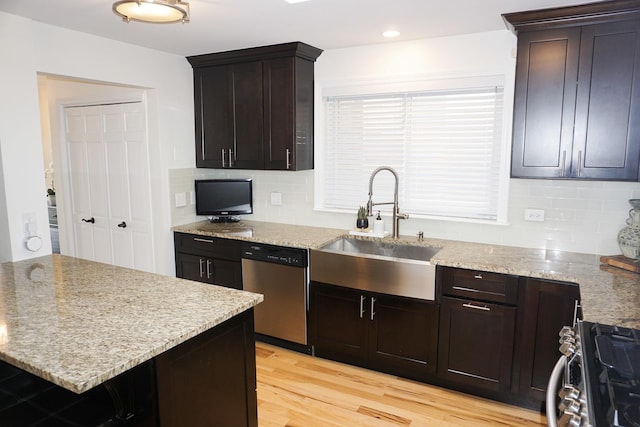 4452 N Newland Ave, Harwood Heights, IL 60706 - kitchen featuring stainless steel appliances, tasteful backsplash, light wood-type flooring, and light stone countertops
