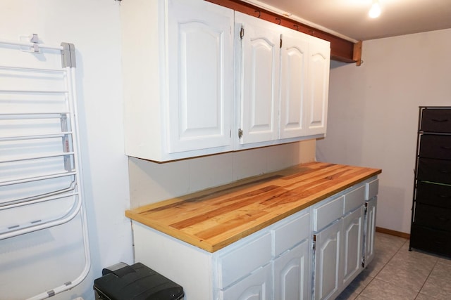 4452 N Newland Ave, Harwood Heights, IL 60706 - kitchen featuring butcher block countertops, white cabinetry, and light tile patterned floors