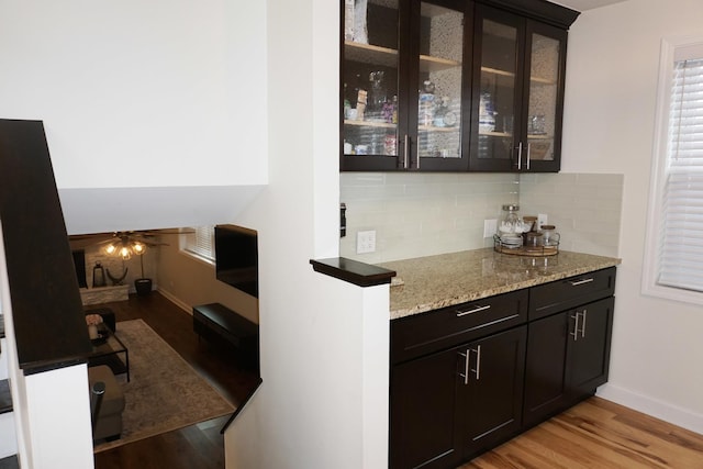 4452 N Newland Ave, Harwood Heights, IL 60706 - bar with backsplash and light wood-style floors