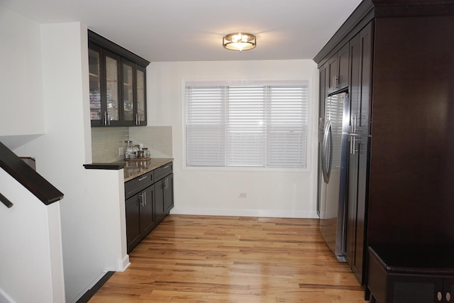 4452 N Newland Ave, Harwood Heights, IL 60706 - kitchen featuring glass insert cabinets, tasteful backsplash, freestanding refrigerator, light wood finished floors, and dark brown cabinets
