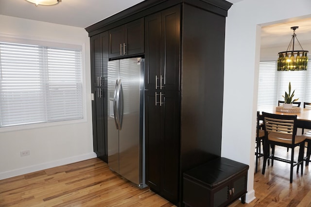 4452 N Newland Ave, Harwood Heights, IL 60706 - kitchen with stainless steel fridge with ice dispenser, light wood finished floors, a chandelier, and hanging light fixtures