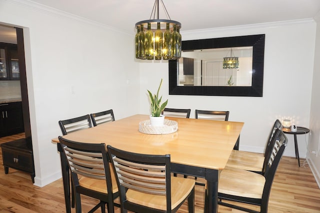4452 N Newland Ave, Harwood Heights, IL 60706 - dining room with light wood-style floors, crown molding, and a chandelier