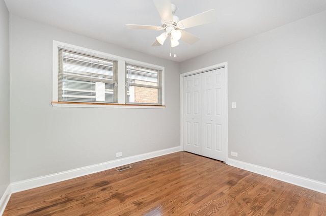 1203 W 110th St, Chicago, IL 60643 - unfurnished bedroom featuring a closet, wood finished floors, and a ceiling fan