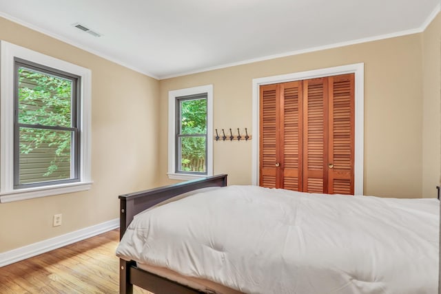 137 School St, Grayslake, IL 60030 - bedroom featuring light wood-style floors, crown molding, and a closet