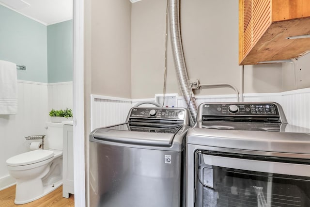 137 School St, Grayslake, IL 60030 - laundry room featuring a wainscoted wall, wood finished floors, separate washer and dryer, and ornamental molding
