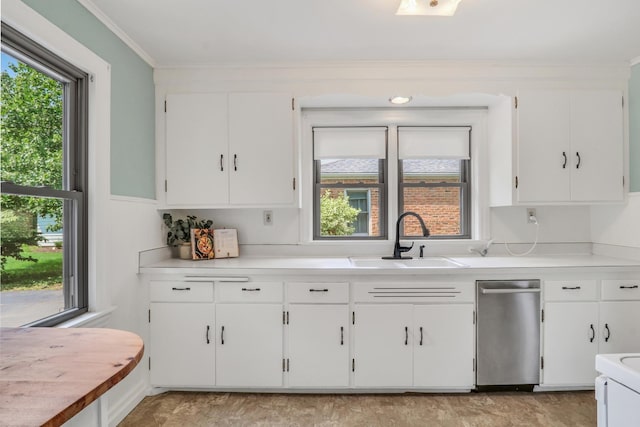 137 School St, Grayslake, IL 60030 - kitchen featuring light countertops, white cabinetry, crown molding, and dishwasher