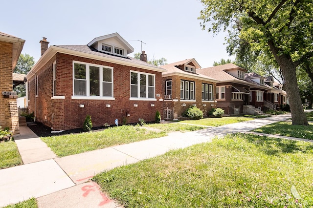 7945 S Avalon Ave, Chicago, IL 60619 - bungalow-style home featuring brick siding, a chimney, and a front lawn