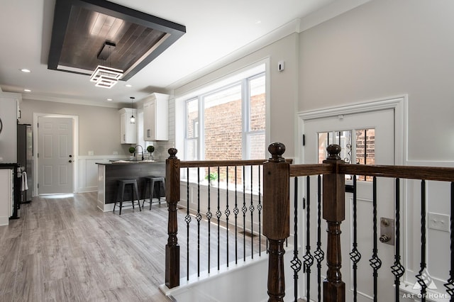 7945 S Avalon Ave, Chicago, IL 60619 - corridor featuring healthy amount of natural light, light wood-type flooring, and ornamental molding