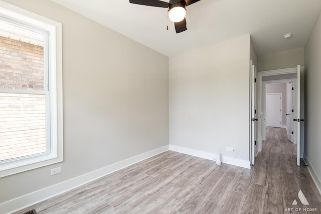 7945 S Avalon Ave, Chicago, IL 60619 - empty room featuring ceiling fan, light wood finished floors, plenty of natural light, and a smoke detector