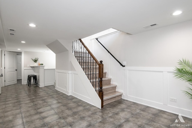 7945 S Avalon Ave, Chicago, IL 60619 - stairs with a decorative wall, recessed lighting, and wainscoting
