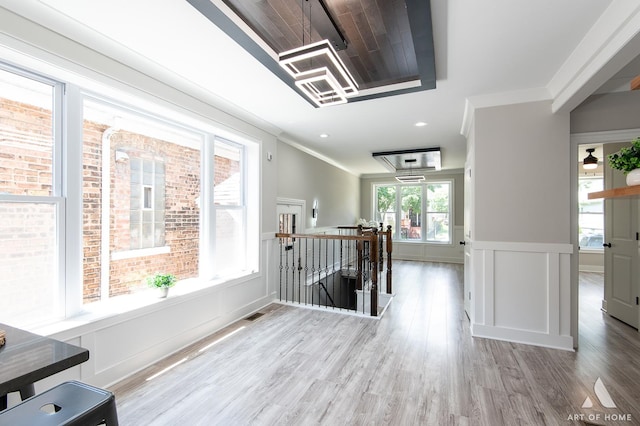 7945 S Avalon Ave, Chicago, IL 60619 - hallway featuring an upstairs landing, wood finished floors, a wainscoted wall, a decorative wall, and crown molding