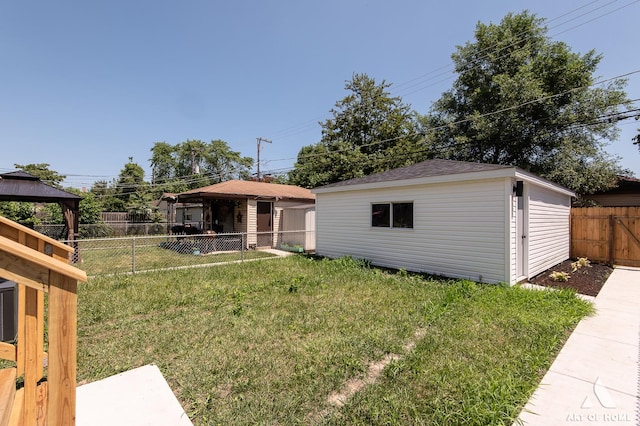 7945 S Avalon Ave, Chicago, IL 60619 - view of front facade featuring a gazebo, a fenced backyard, and an outbuilding