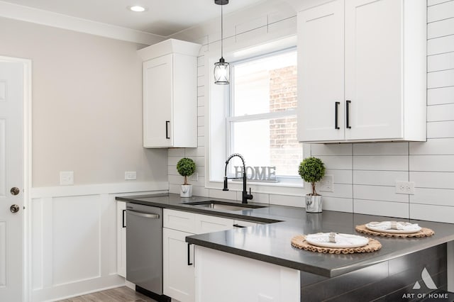 7945 S Avalon Ave, Chicago, IL 60619 - kitchen with stainless steel dishwasher, dark countertops, white cabinets, decorative light fixtures, and decorative backsplash