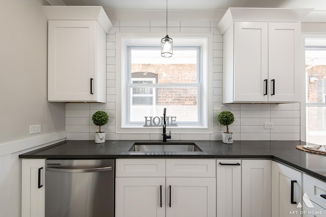 7945 S Avalon Ave, Chicago, IL 60619 - kitchen with dishwasher, dark countertops, backsplash, and white cabinetry