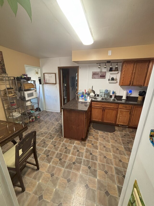 4304 N Oriole Ave, Norridge, IL 60706 - kitchen featuring brown cabinets, dark countertops, and a peninsula
