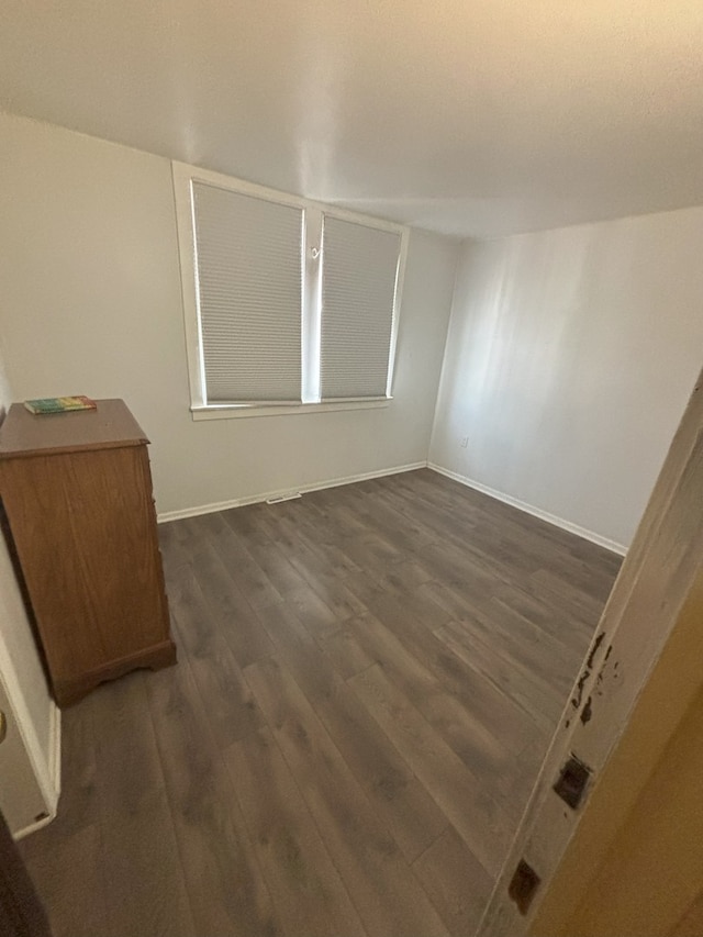 4304 N Oriole Ave, Norridge, IL 60706 - empty room featuring dark wood-type flooring and baseboards
