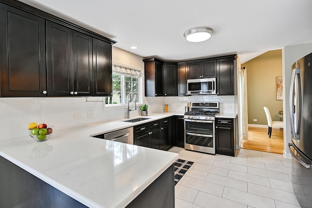 1501 Pine View Ct, Darien, IL 60561 - kitchen featuring appliances with stainless steel finishes, tasteful backsplash, light countertops, recessed lighting, and a peninsula