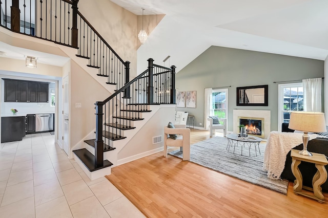 1501 Pine View Ct, Darien, IL 60561 - living area with high vaulted ceiling, plenty of natural light, a chandelier, and stairs