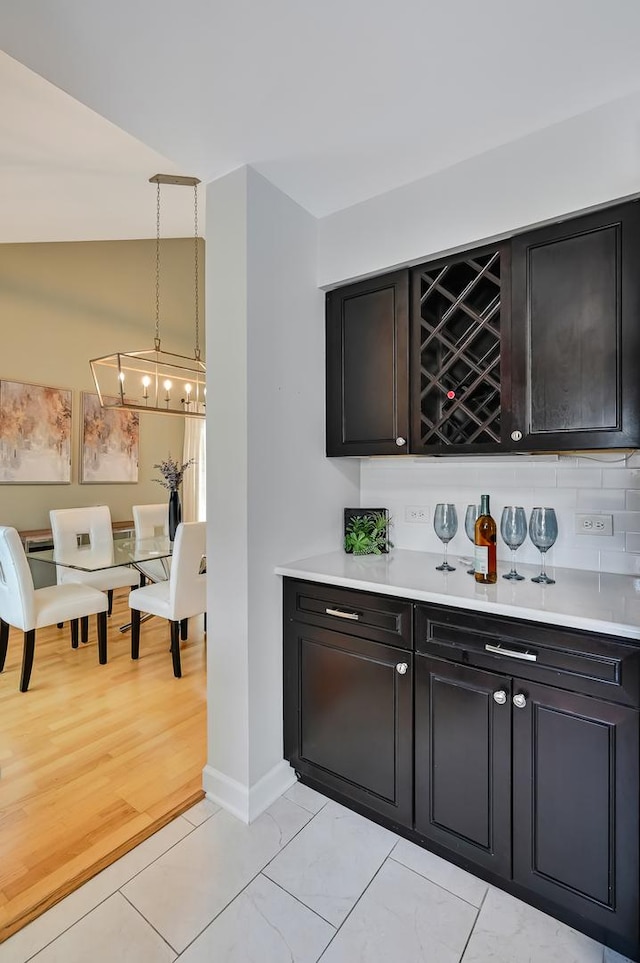 1501 Pine View Ct, Darien, IL 60561 - indoor dry bar with decorative backsplash, decorative light fixtures, and light tile patterned floors