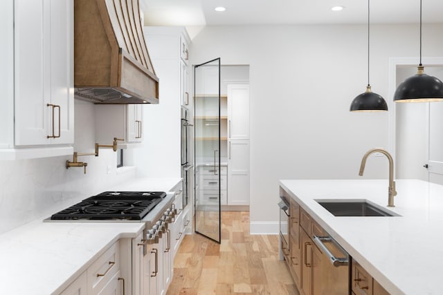 223 Center St, Naperville, IL 60540 - kitchen featuring custom exhaust hood, stainless steel appliances, light wood finished floors, recessed lighting, and white cabinets