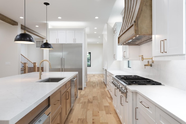 223 Center St, Naperville, IL 60540 - kitchen featuring custom exhaust hood, light wood-style floors, recessed lighting, white cabinetry, and decorative light fixtures