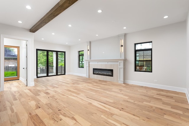 223 Center St, Naperville, IL 60540 - unfurnished living room featuring light wood finished floors, healthy amount of natural light, a glass covered fireplace, recessed lighting, and beam ceiling