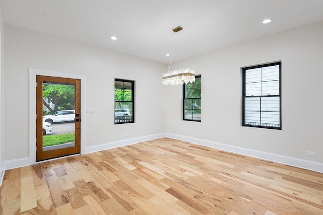 223 Center St, Naperville, IL 60540 - spare room featuring light wood-style flooring, a chandelier, and recessed lighting